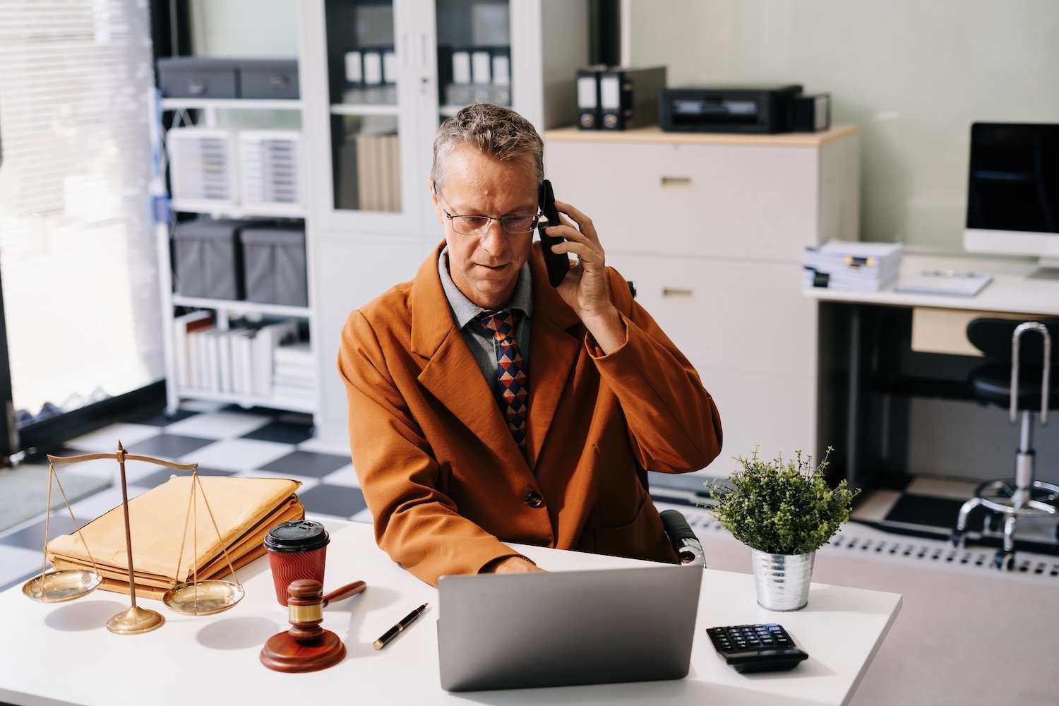 Defense attorney on the phone with a prosecutor discussing a plea deal