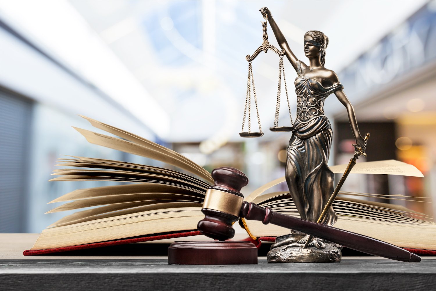 Lady justice with a law book and a gavel