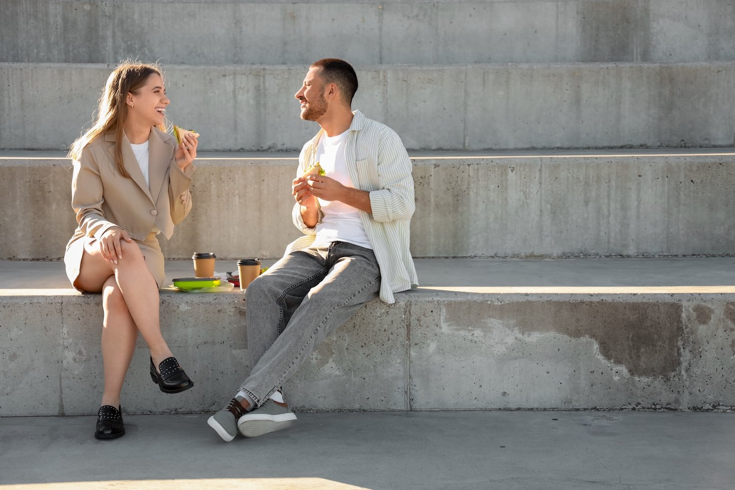 Two work colleagues enjoying an outdoor lunch during the work day